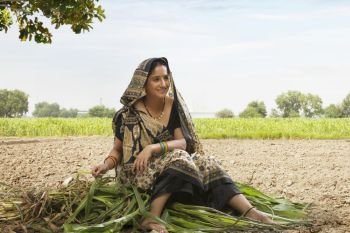 Rural woman sitting in the paddy field