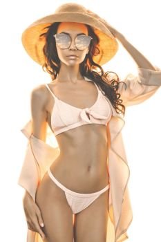 Sunny fashion photo of beautiful slender woman in pink bikini and straw hat. Beach summer vibes