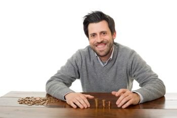 Man examines coins on a desk, isolated 
