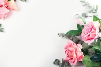 Roses with leaves. Pink Roses with leaves, flat lay flower frame on white background