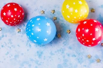 Bright colorful carnival or party scene. Bright colorful carnival or party scene of balloons on blue table background. Flat lay style, birthday or party greeting card with copy space.