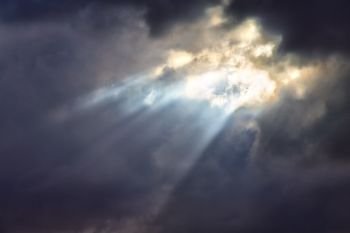 in the cloudy sky a ray of light like concept of holy paradise and  peace. in the cloudy sky a   ray of light  