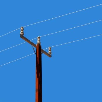 in  australia the concept of power line with electrical pole in the clear sky. power line with electrical pole in the clear sky