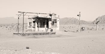 in iran old gas station  the desert mountain background and nobody