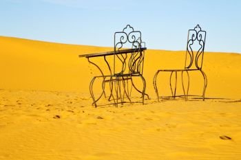 table and seat in  desert sahara morocco   africa yellow sand
