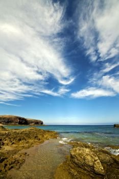 rock stone sky cloud beach  water  coastline and summer in lanzarote spain