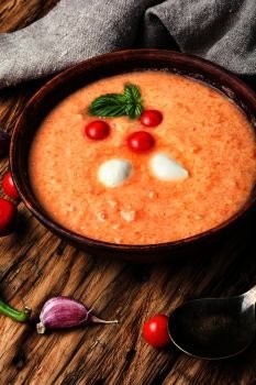 Gazpacho rustic soup. Gazpacho soup with tomato on retro wooden background