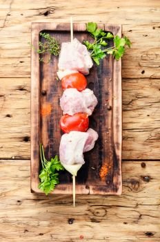 Marinated raw kebabs for barbecue. Kebab, threaded on skewers pieces of meat
