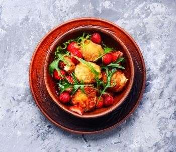Salad with strawberry and fried cheese. Salad with strawberries, fried cheese and rucola.Healthy eating,