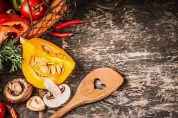 Autumn vegetarian cooking with pumpkin, Mushrooms and vegetables on rustic wooden background with cooking spoon, top view. Healthy  food and eating  concept