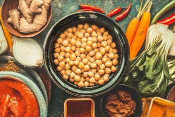 Chickpeas in bowl and various healthy  cooking ingredients. Vegan or vegetarian food and eating concept