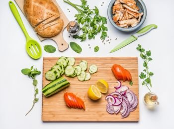 Healthy lunch cooking.  Clean eating layout and diet nutrition concept. Various fresh vegetables ingredients and roasted chicken or turkey meat for salad on white table background, top view