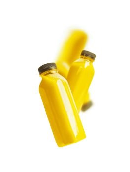 Flying yellow smoothie or juice bottle , isolated on white background. Branding copy space