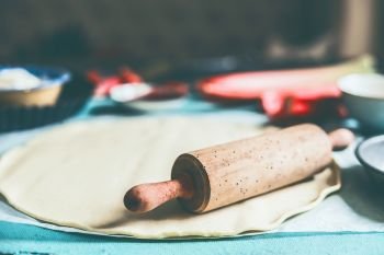 Pizza Dough and rolling pin on kitchen table