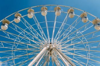 White Ferris Wheel On Summer Blue Sky In Fun Park