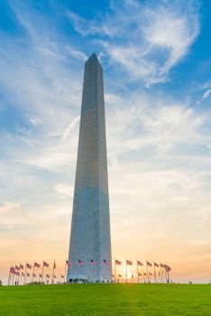 The sun low in the sky with behind the Washington Monument in Washington DC
