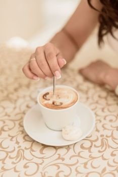 bride drinking cappuccino on the background of painted tablecloths