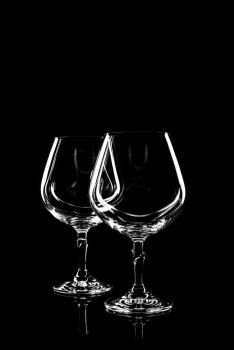 transparent glass for wine on black background with reflection