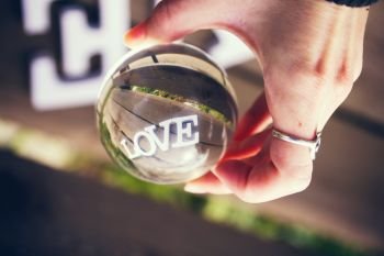Love word looking through a crystal ball 