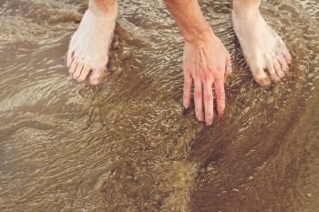 Hand and feet in sea water 