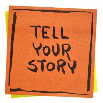 Tell your story inspirational  advice - handwriting on an isolated sticky note