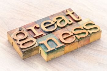 greatness word abstract in letterprtess wood type blocks stained by color inks
