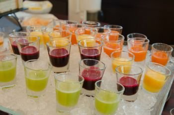 Fresh and healthy  fruit juice in cups on cold ice