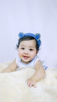 Asian Smiling baby girl . Asian Smiling baby girl crawling in bedroom