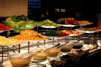 healthy food, vegetables salad bar on buffet line in restaurant
