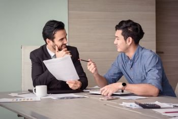 young asian and caucasian businessman discuss business project in meeting room office