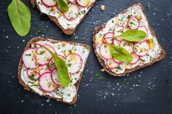 Delicious vegetarian sandwiches. Delicious sandwiches with soft cream cheese and radish. Vegetarian food.