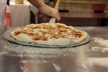 Putting Raw Pizza into Oven with Spatula, Italian Mushrooms Pizza Preparation
