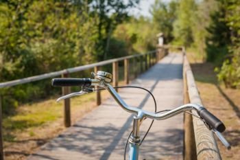 Bike path and bicycle handlebar close-up. Bicycle friendly city. Eco-friendly transport and healthy lifestyle concept.