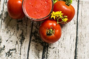 Tomato smoothie - tomato juice on wood background