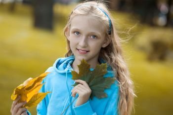 Portrait of Little Girl Enjoying a Sunny Autumn Day in Park