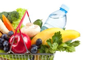 Shopping Concept: Close-up of Perfect Shopping Cart Filled with Mineral Water, Bananas, Grapes, Apple, Celery, Champignons, Cucumber, Green Onions, Bromeliads, Salad, Carrots, Parsley on White Background