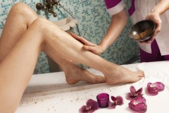 Spa salon: Beautiful Young Woman having Depilation on Legs with Sugar