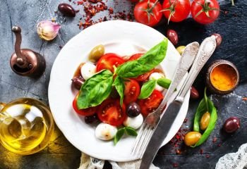 caprese salad on plate and on a table