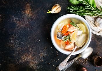 fish soup. fish soup in bowl, fresh soup with salmon and greens