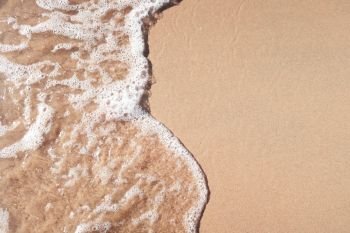 Transparent soft wave on sandy beach