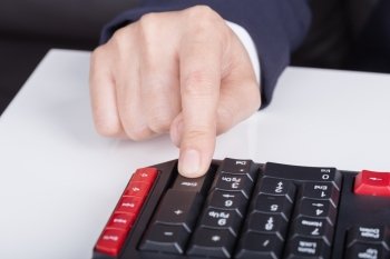 finger pushing enter button on a keyboard of computer