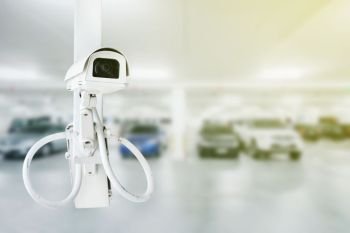 CCTV security camera with blurred car parking background