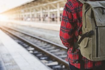 Young Asian woman backpacker traveler walking alone at train sta. Young Asian woman backpacker traveler walking alone at train station platform with backpack. Asian woman waiting train at train station for travel. Summer holiday traveling or young tourist concept.