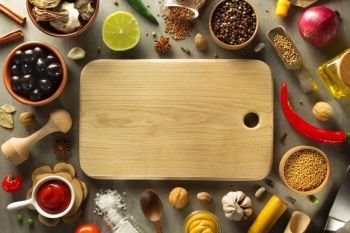 herbs and spices and wooden cutting board