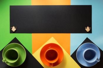 cup and saucer at colorful paper background