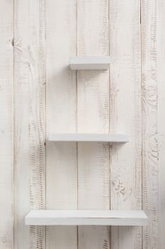 wooden shelves at white wall background texture