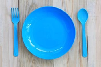 Blue dish empty on wooden floor and have copy space.. Blue dish empty on wooden floor and have copy space for design in your work.