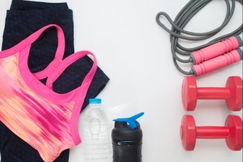 Flat lay of sport clothing and equipments on white background, Healthy and workout concept