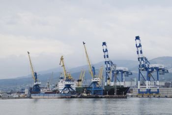 The international sea port of Novorossiysk. Port cranes and industrial objects. Marine Station.. Novorossiysk, Russia - May 28, 2016: The international sea port of Novorossiysk. Port cranes and industrial objects. Marine Station.