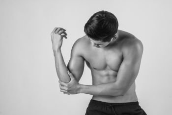 Portrait of a muscle man having elbow pain isolated on white background
. Portrait of a muscle man having elbow pain isolated on white bac